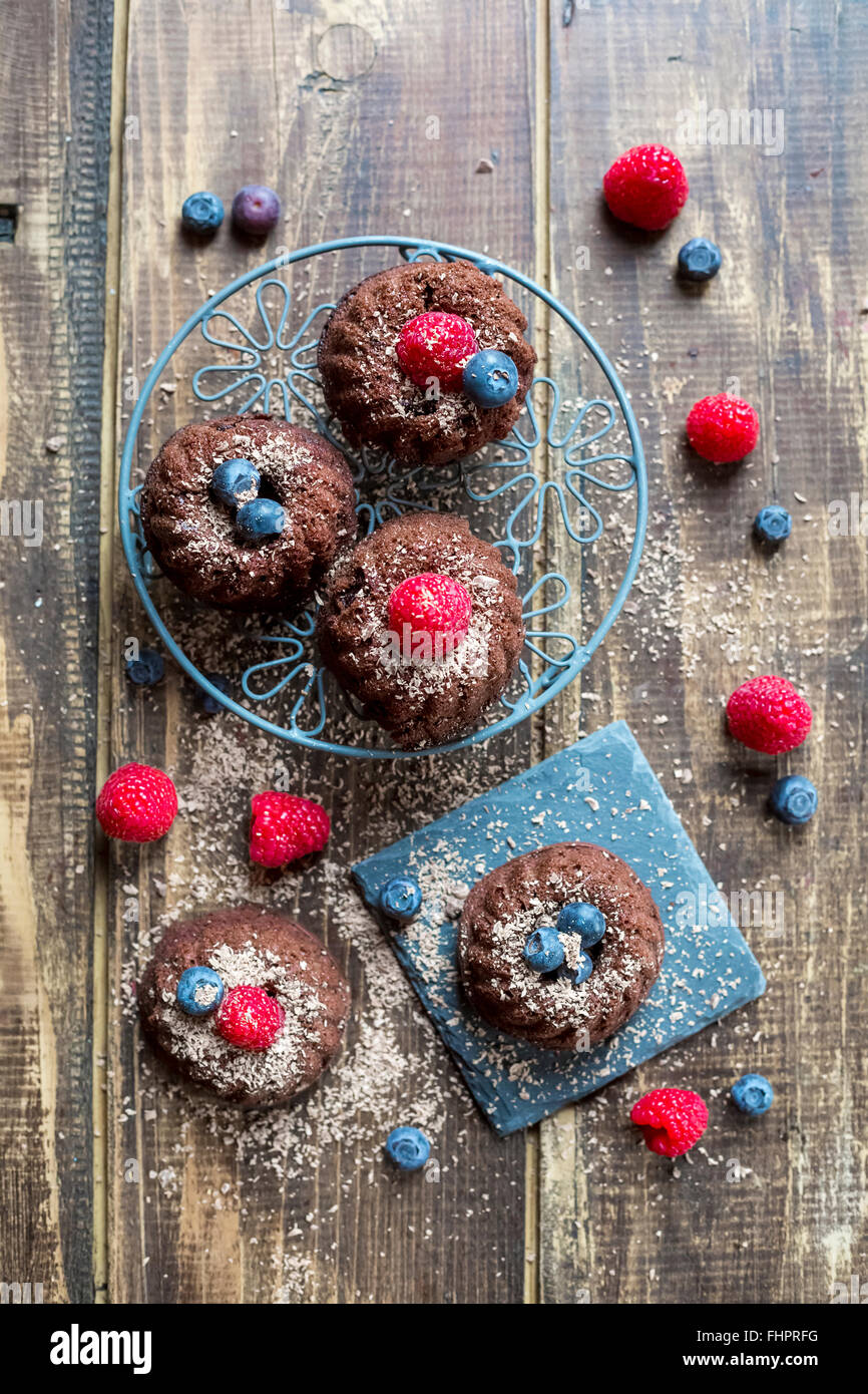 Mini cakes with raspberries and blueberries Stock Photo - Alamy