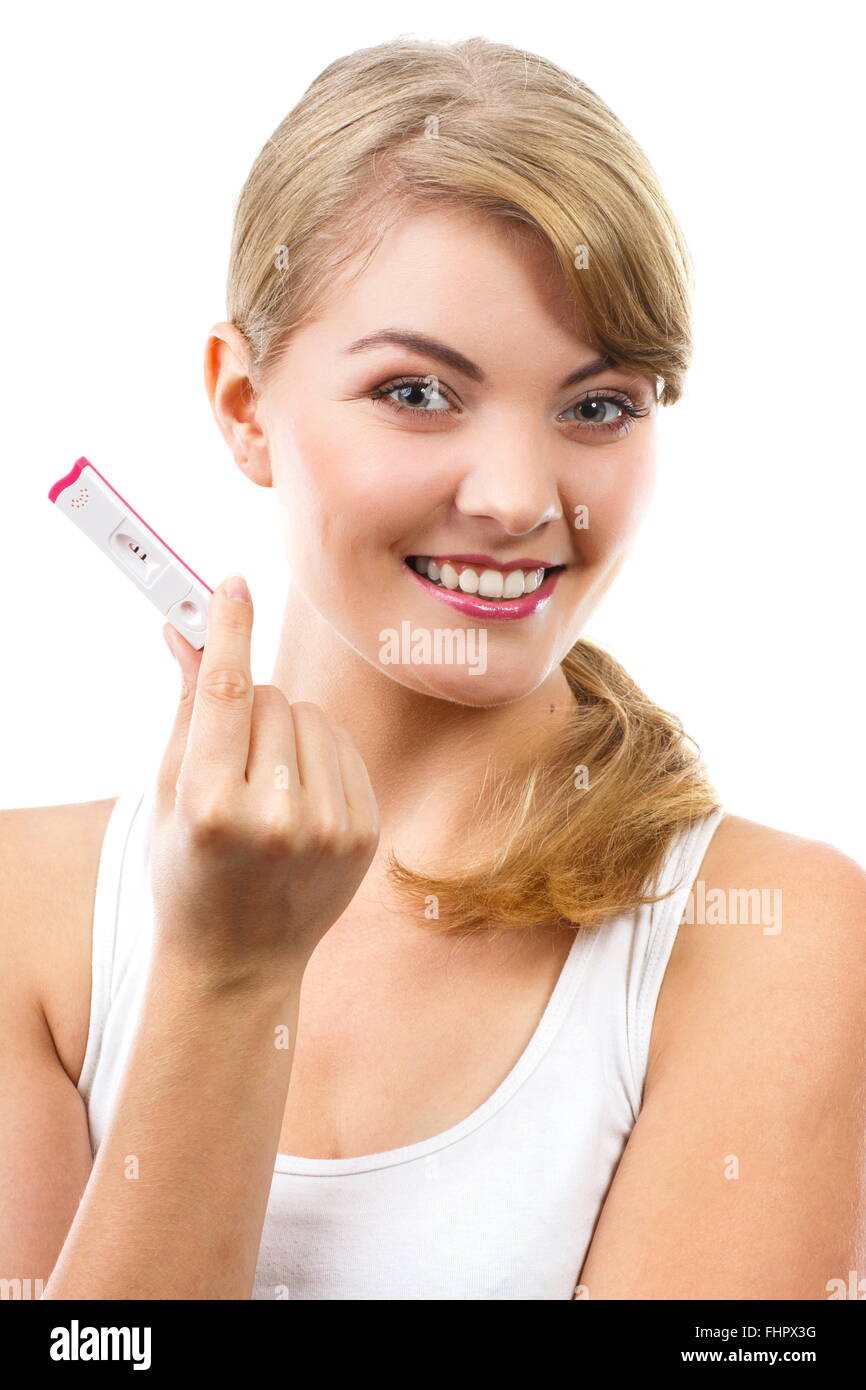 Happy delighted woman showing pregnancy test with positive result