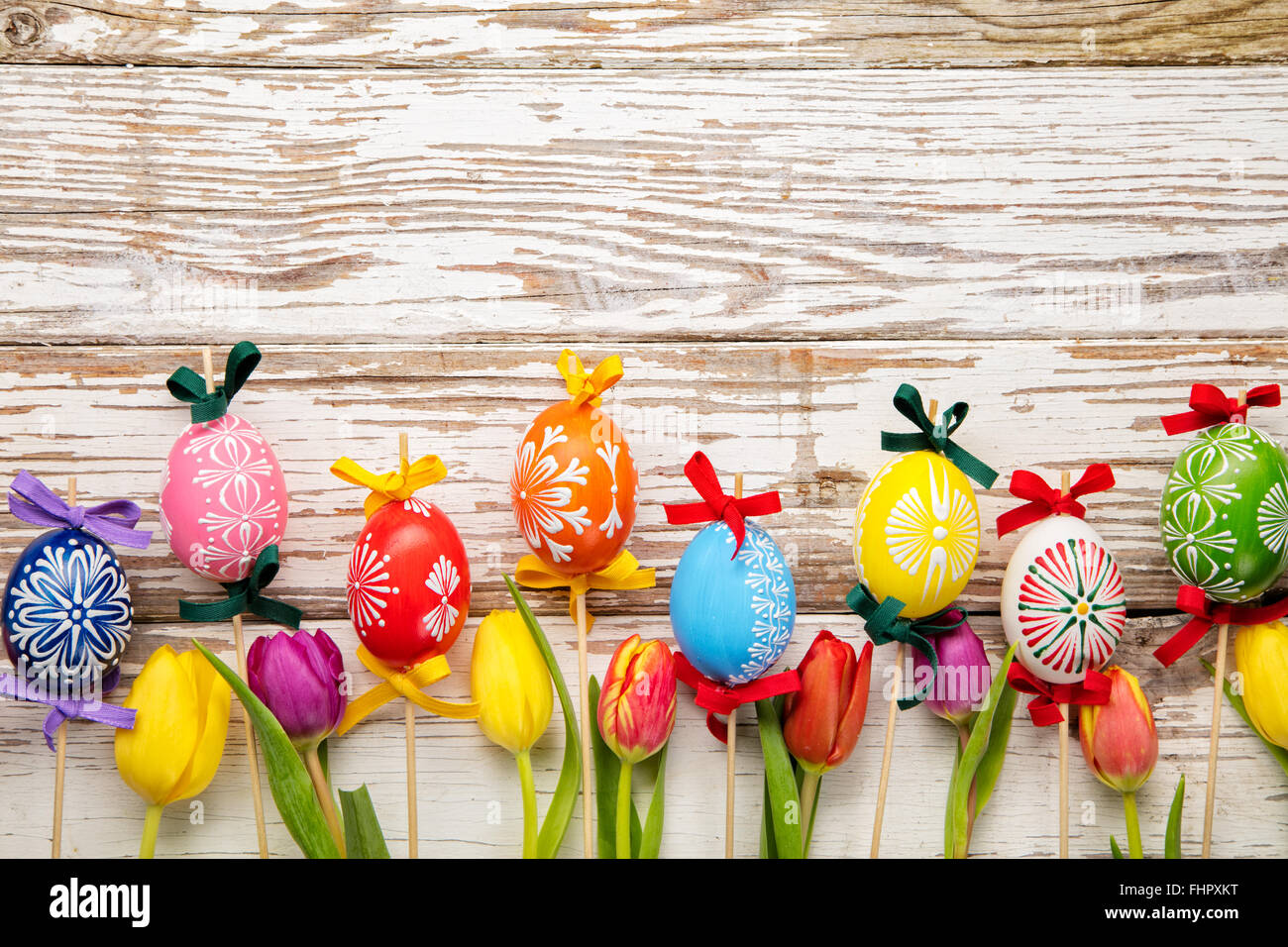 Easter eggs and tulips on wooden planks Stock Photo - Alamy