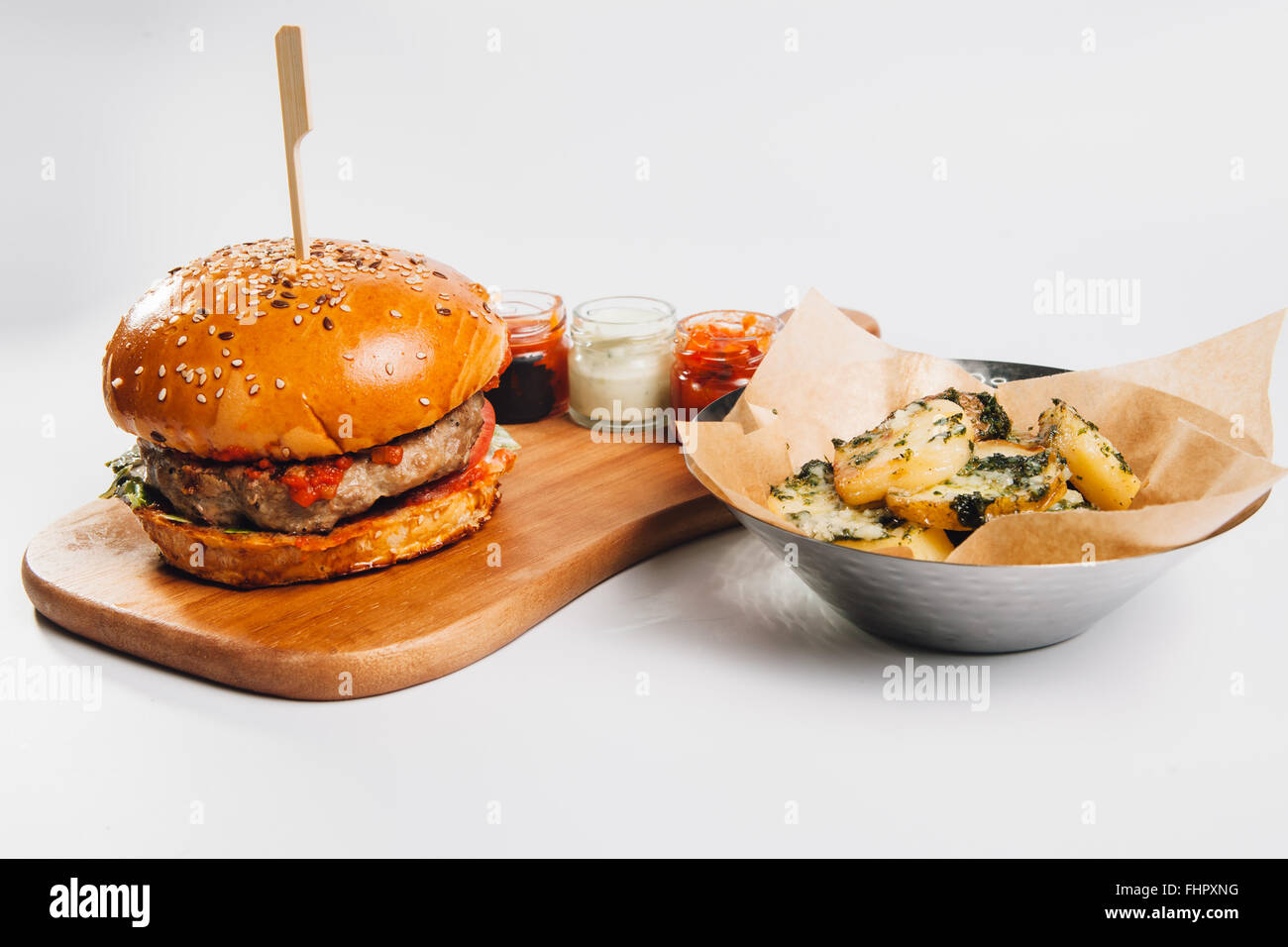burger with fries on wooden plate Stock Photo
