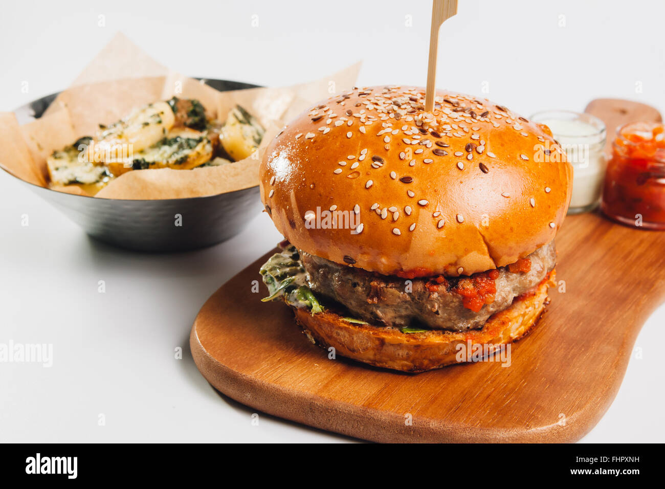 Burger With Fries On Wooden Plate Stock Photo Alamy