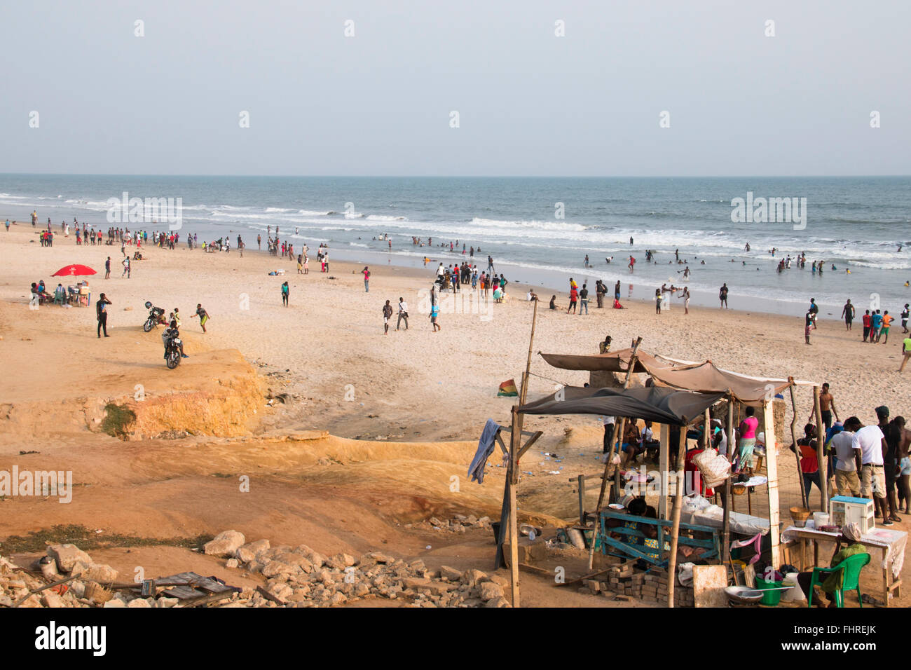 ACCRA, GHANA - JANUARY 2016: Food stall surrounded by people on the beach in Accra, Ghana at the Gulf of Guinea Stock Photo