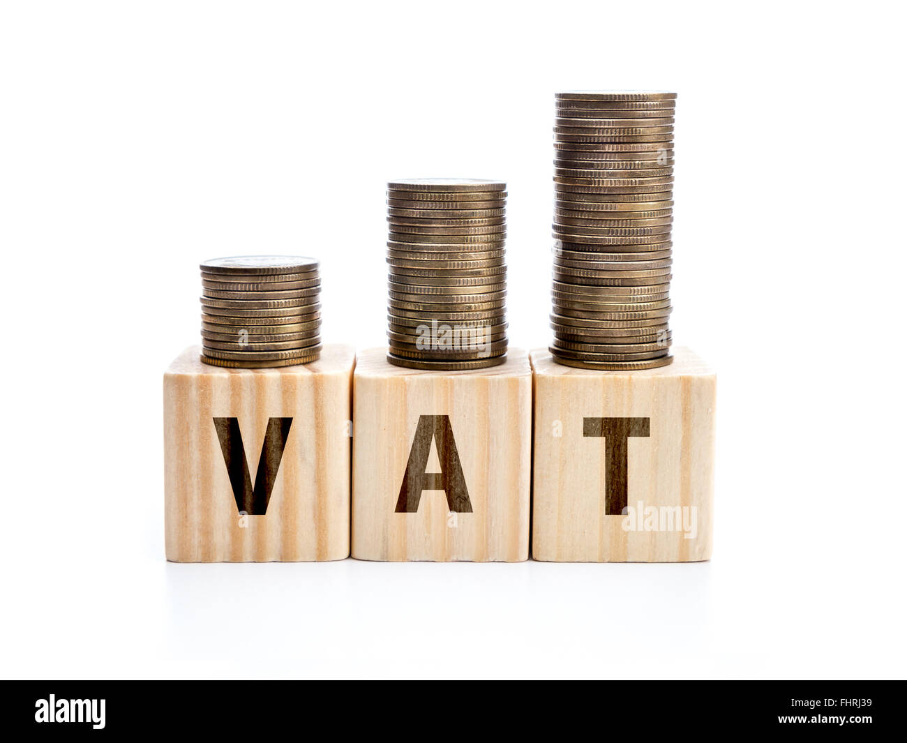 Piles of coins arranged in increased manner placed on wooden block with VAT word Stock Photo