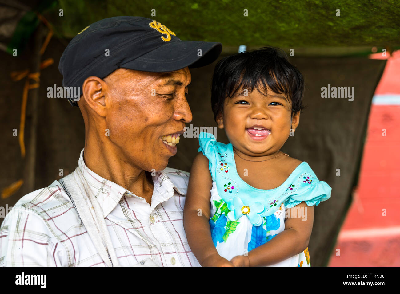 Smiling man with child, little girl in his arms, PaO hilltribe or mountain people, Kalaw, Shan State, Myanmar, Burma Stock Photo