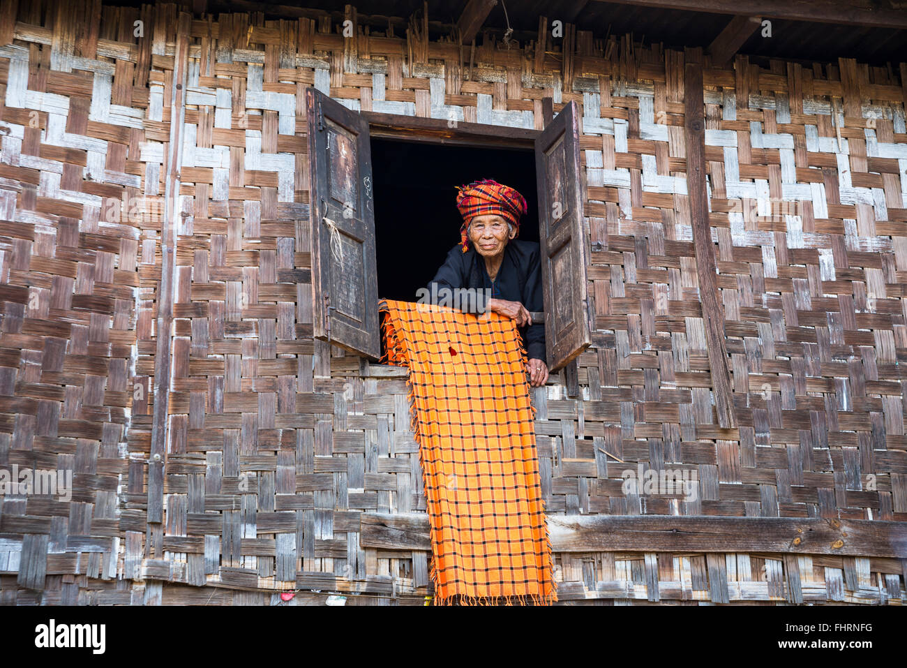 Old woman looking out of a lodge window, mountain tribe or mountain people of the Pa-O or Pa-Oh or Pao or Black Karen or Stock Photo