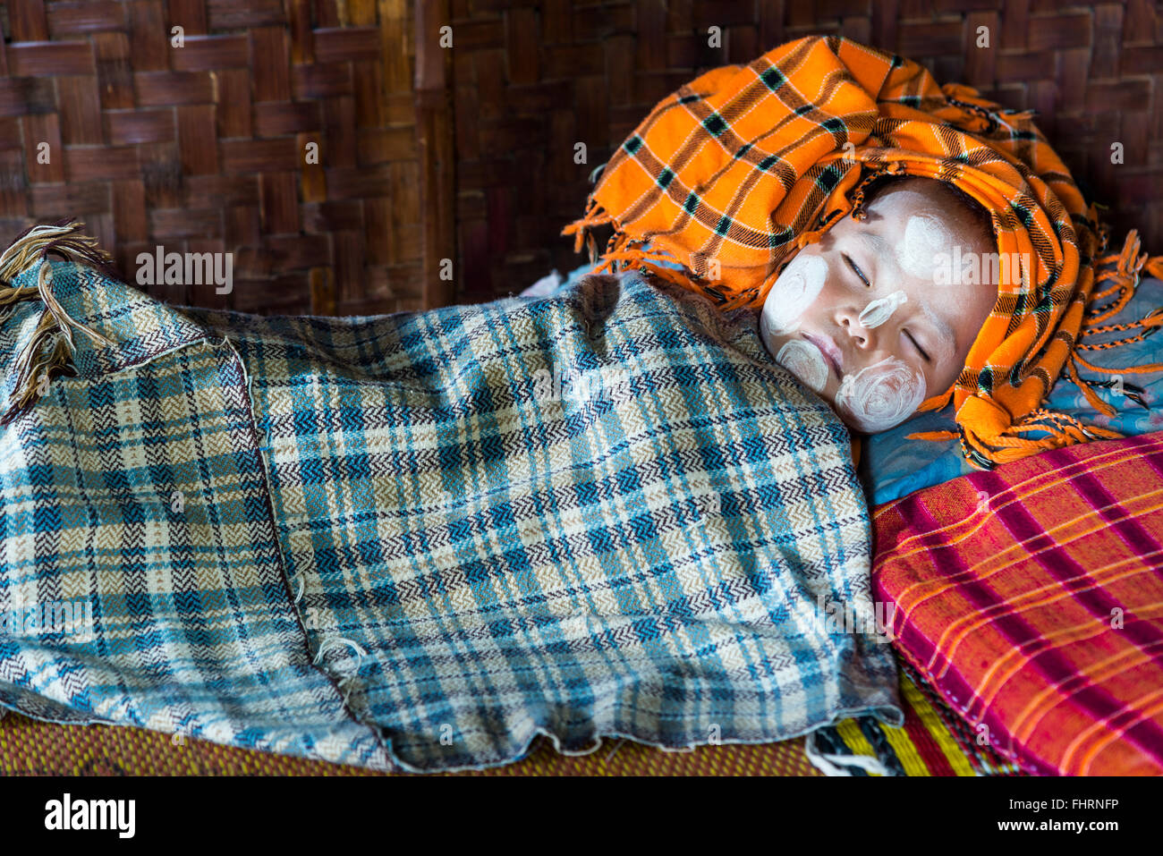 Sleeping child with Thanaka paste on the face, mountain tribe or mountain people Pa-O or Pa-Oh or Pao or Black Karen or Taungthu Stock Photo