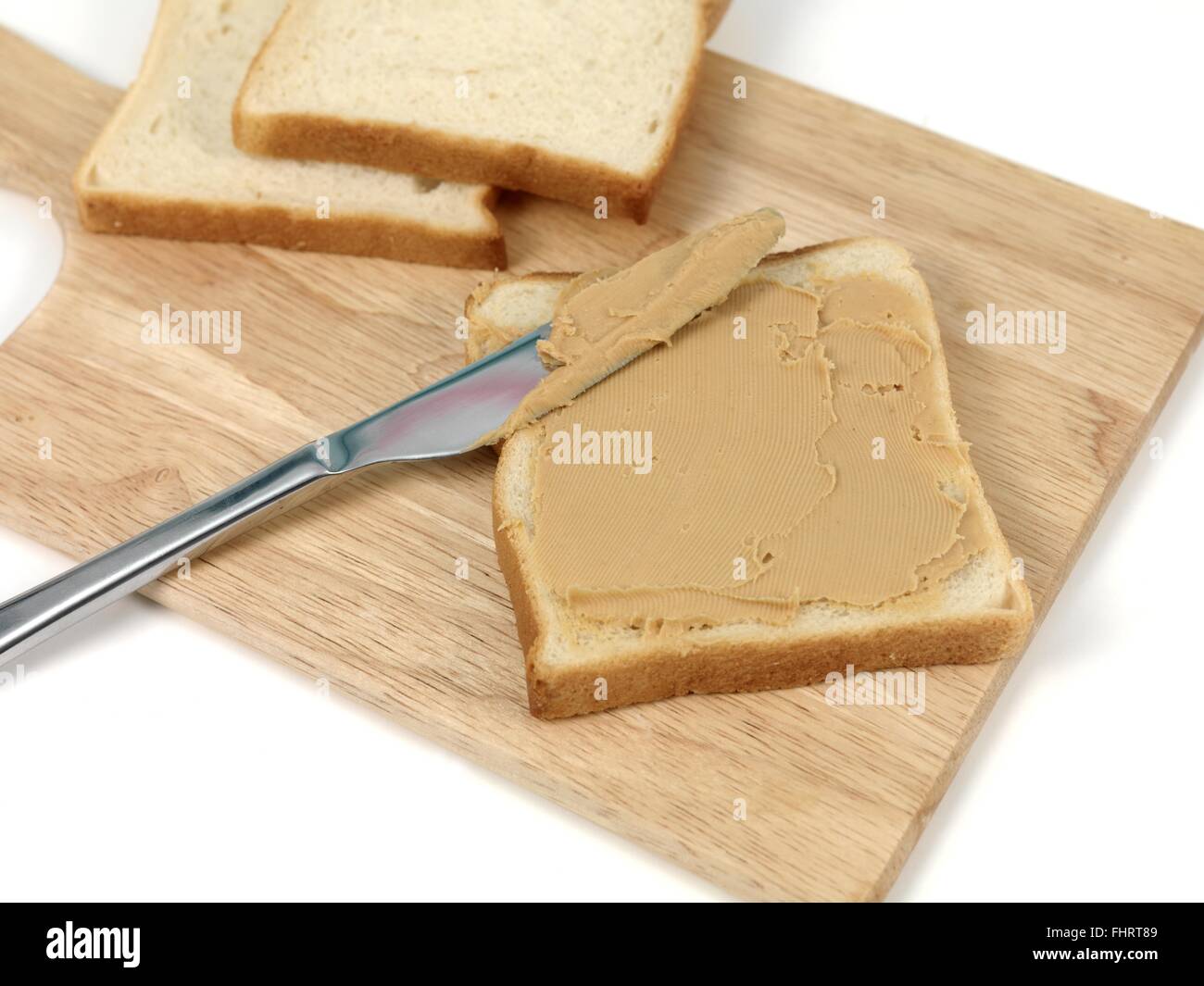 A slice of white bread with peanut butter Stock Photo Alamy