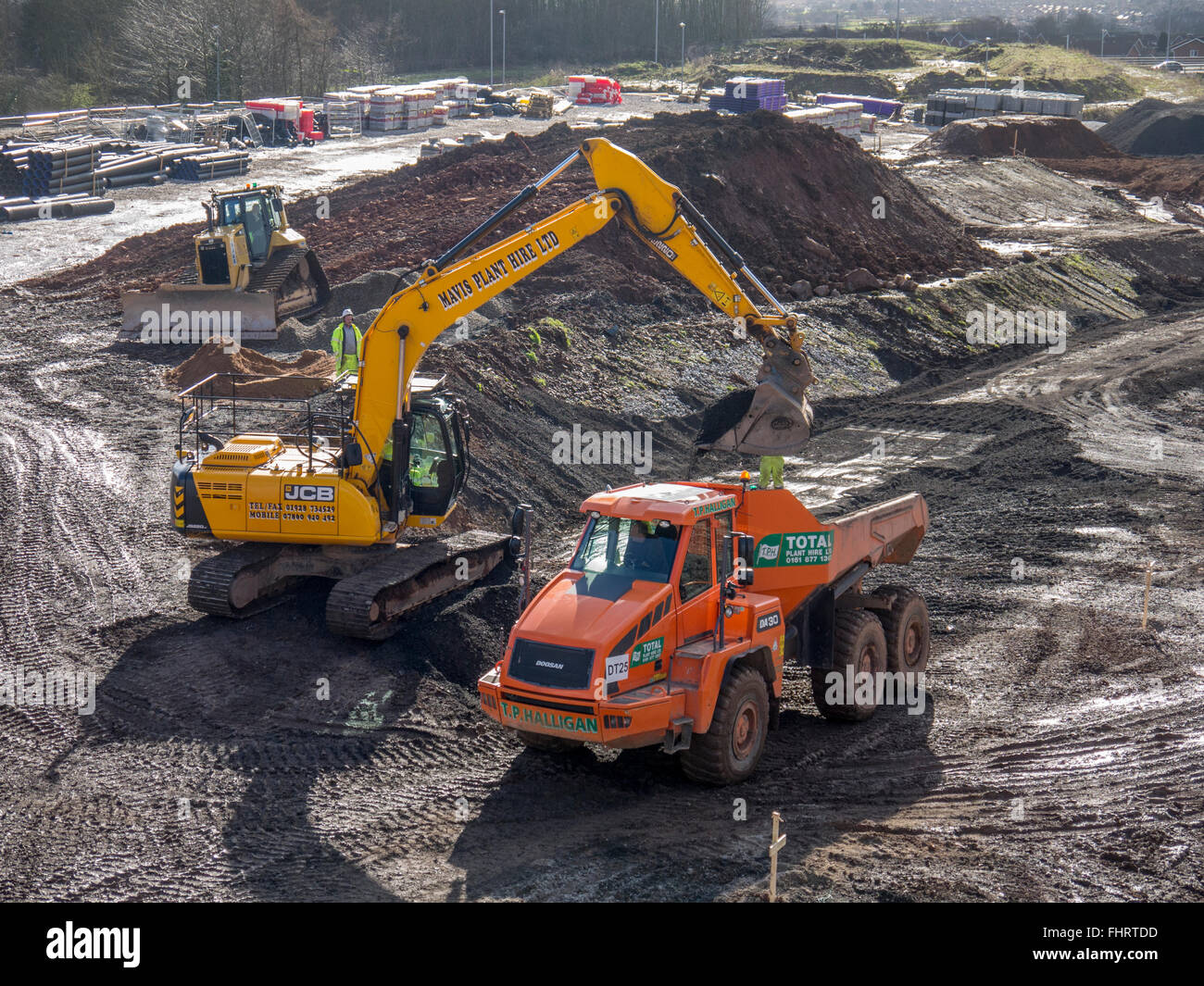 Dump truck being loaded by a digger on a construction site Stock Photo