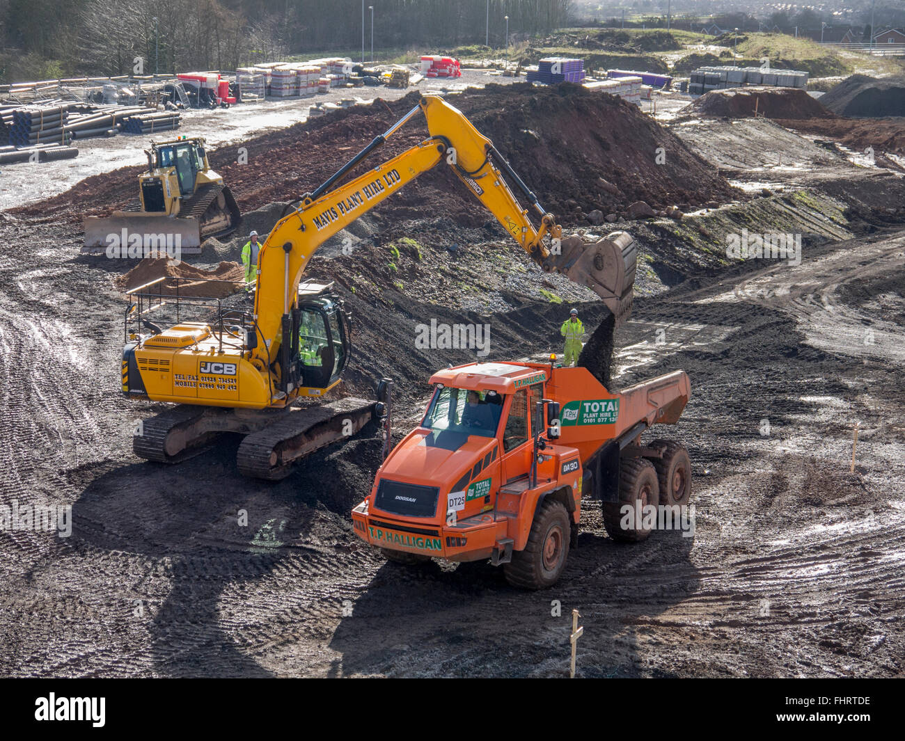 Dump truck being loaded by a digger on a construction site Stock Photo