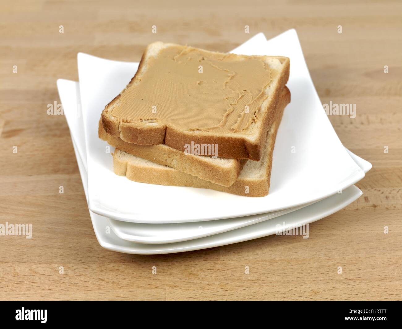 A slice of white bread with peanut butter Stock Photo Alamy