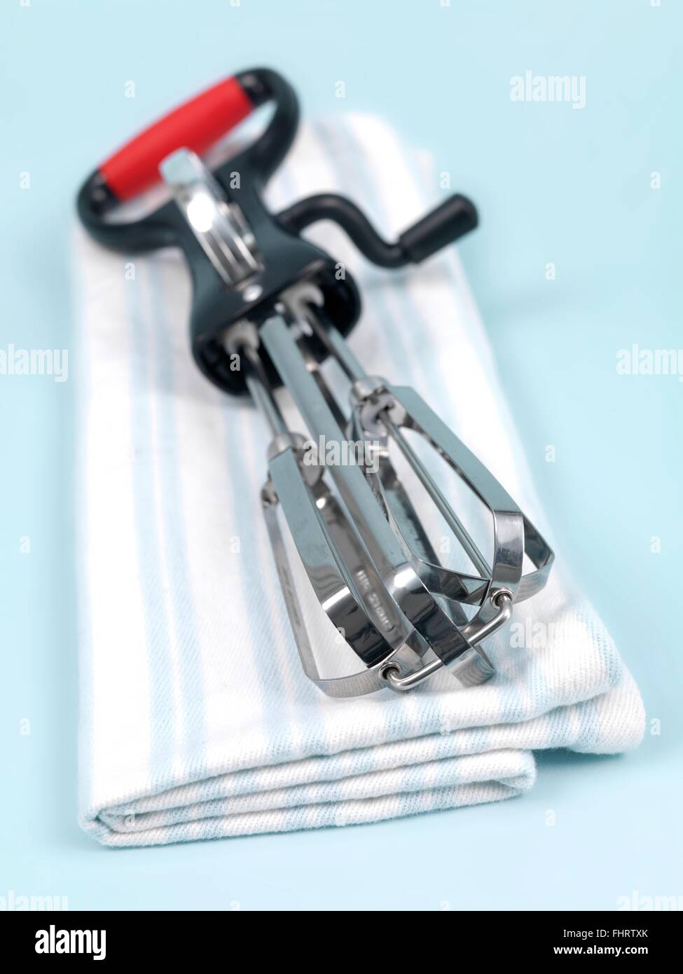 An egg beater on a kitchen bench Stock Photo