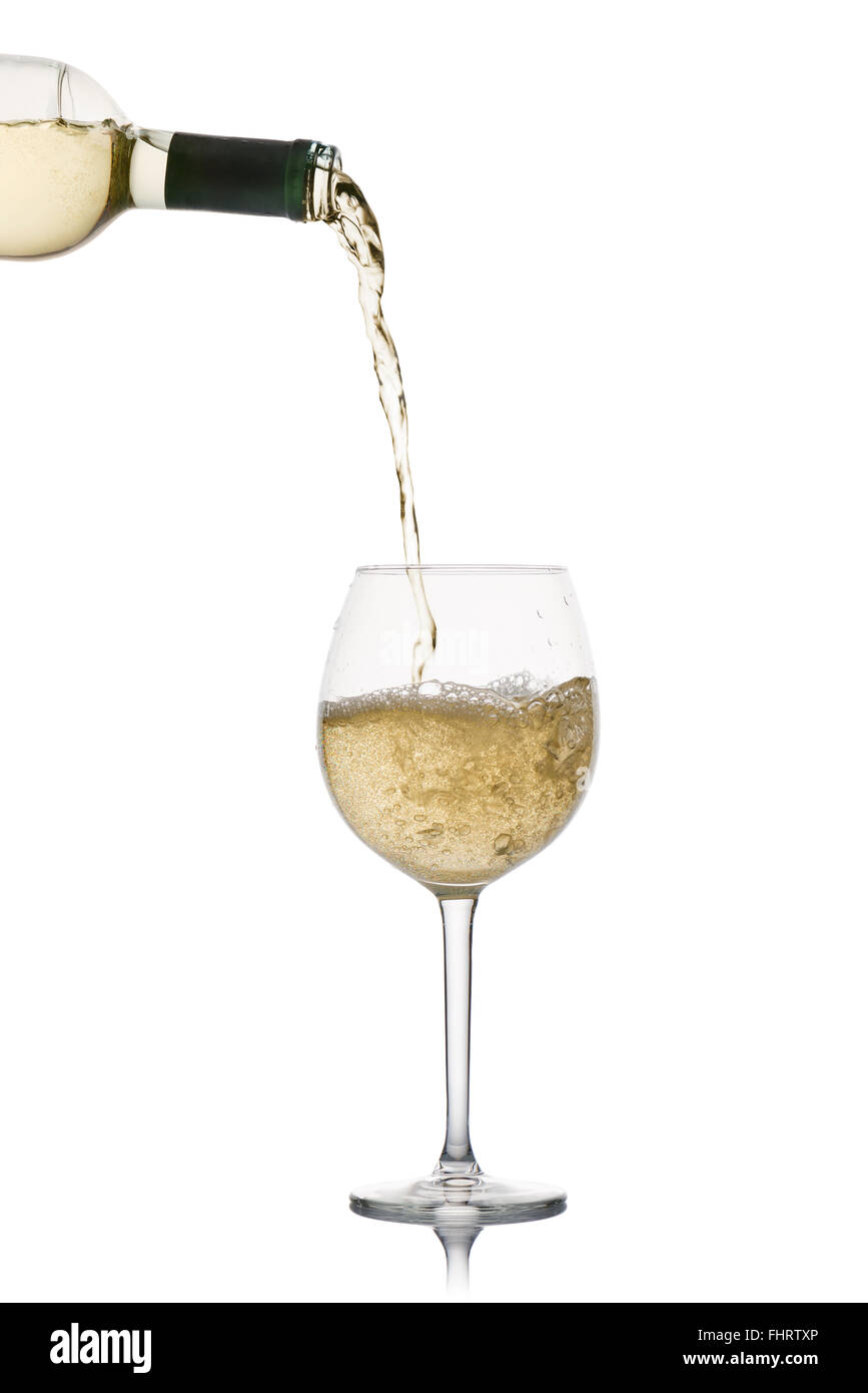 pouring white wine into glass, on white background Stock Photo - Alamy