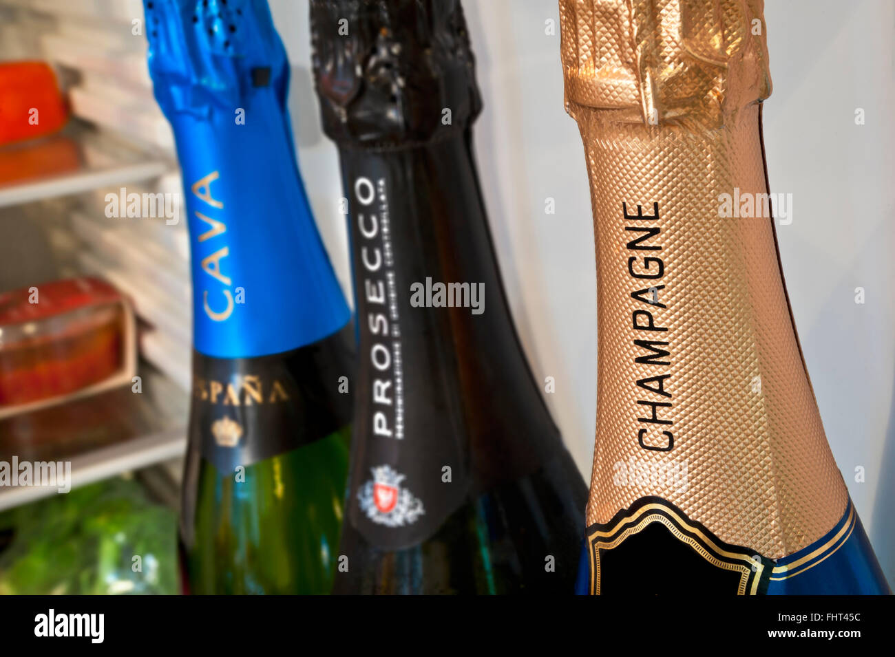 CHAMPAGNE PROSECCO CAVA Selection of chilled European sparkling wines in domestic refrigerator door Champagne in foreground Prosecco & Cava behind Stock Photo