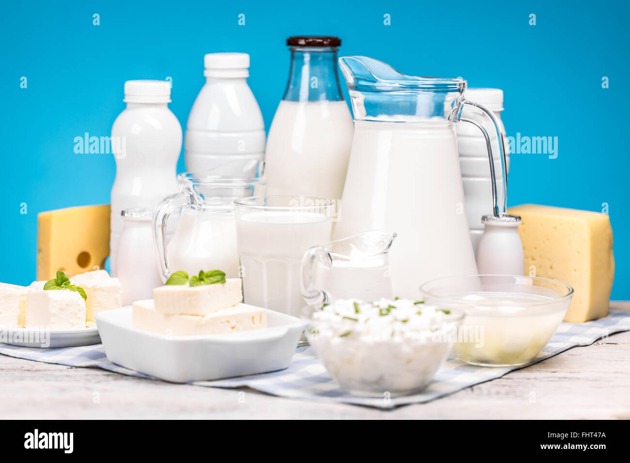 Dairy products on wooden table over blue background Stock Photo