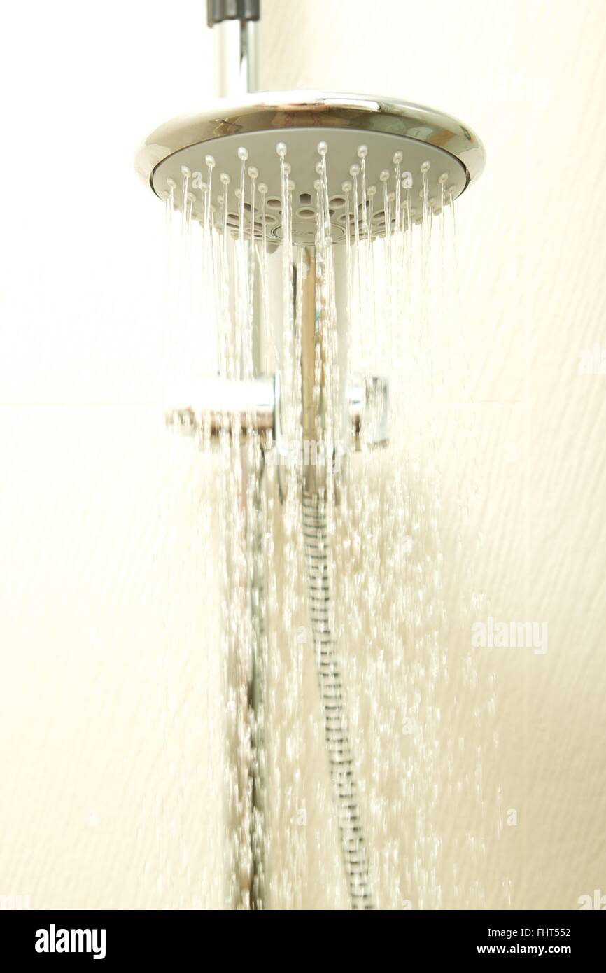 A hotel shower head flowing with water Stock Photo Alamy