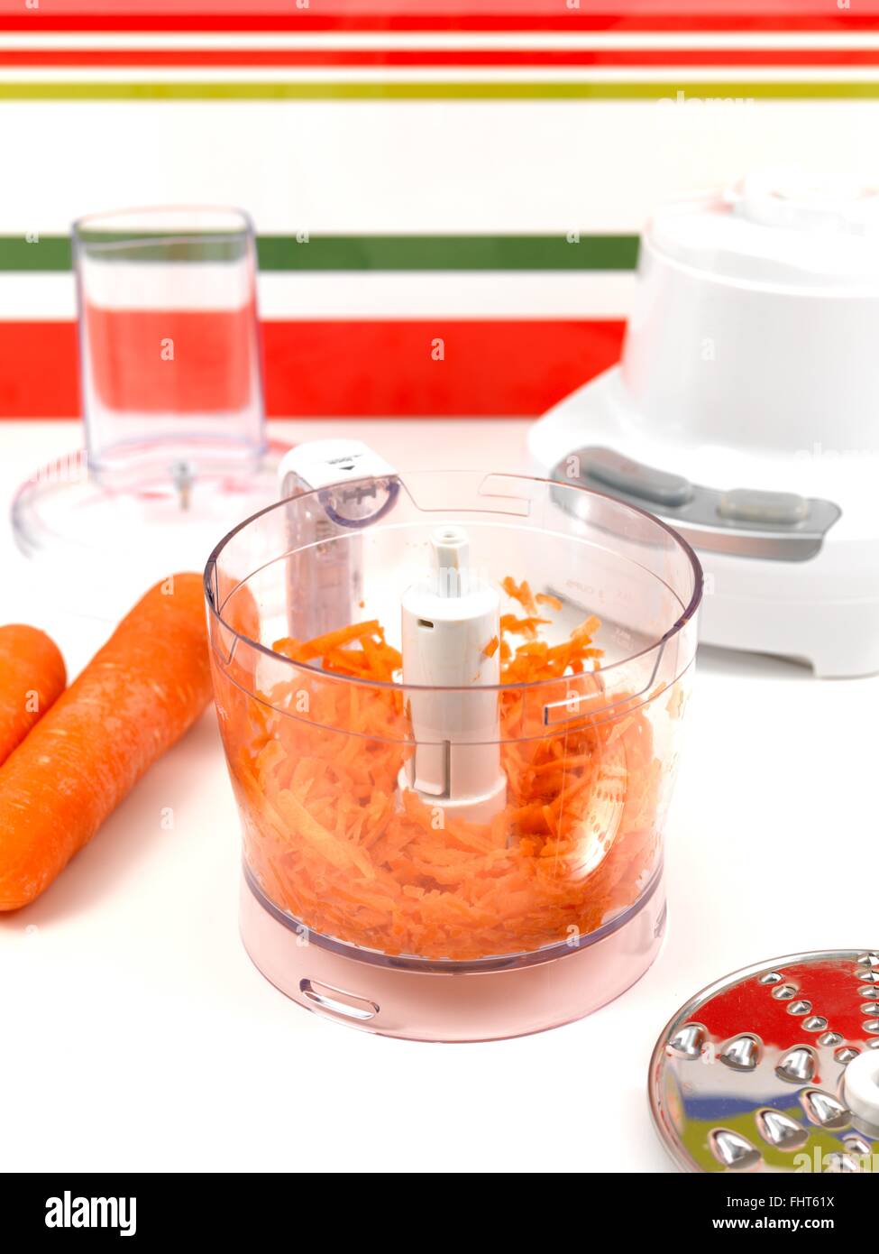Grinding Carrots Using An Electric Food Processor Stock Photo