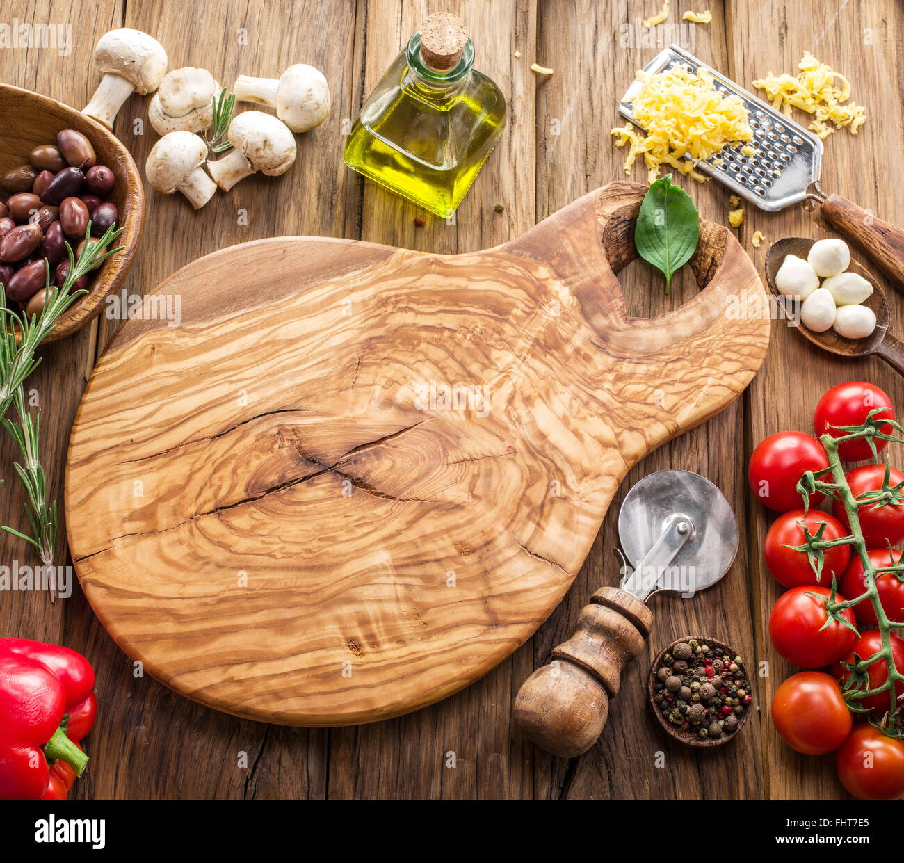 Pizza ingredients: mushrooms, olives, cheese and tomatoes. Stock Photo