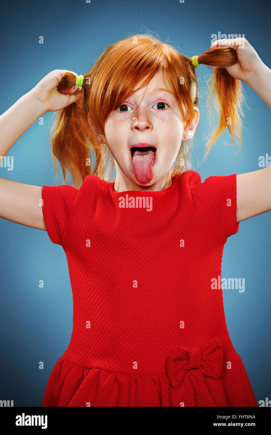 The beautiful portrait of a little girl with his tongue hanging out