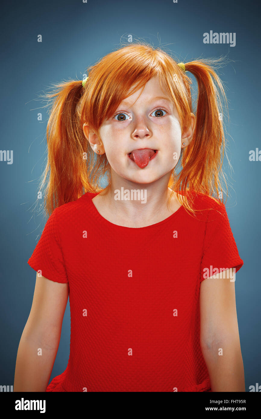 The beautiful portrait of a little girl with his tongue hanging out