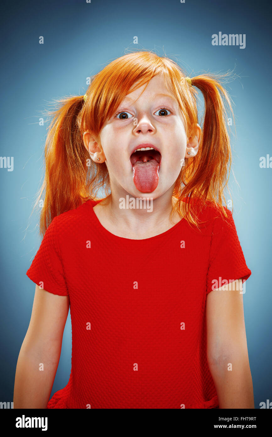 The beautiful portrait of a little girl with his tongue hanging out