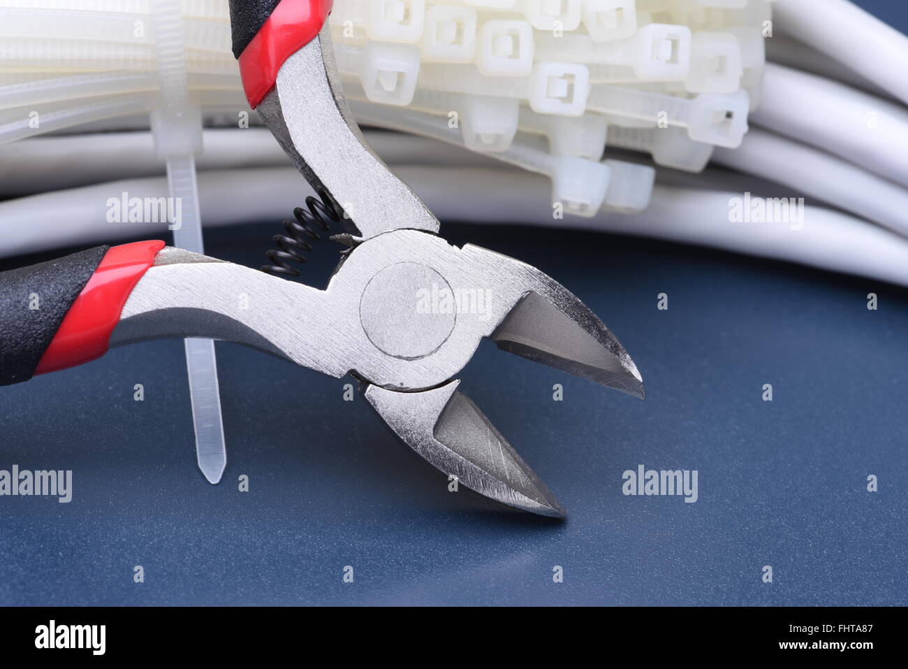 Pliers with cables and bunch of cable ties Stock Photo