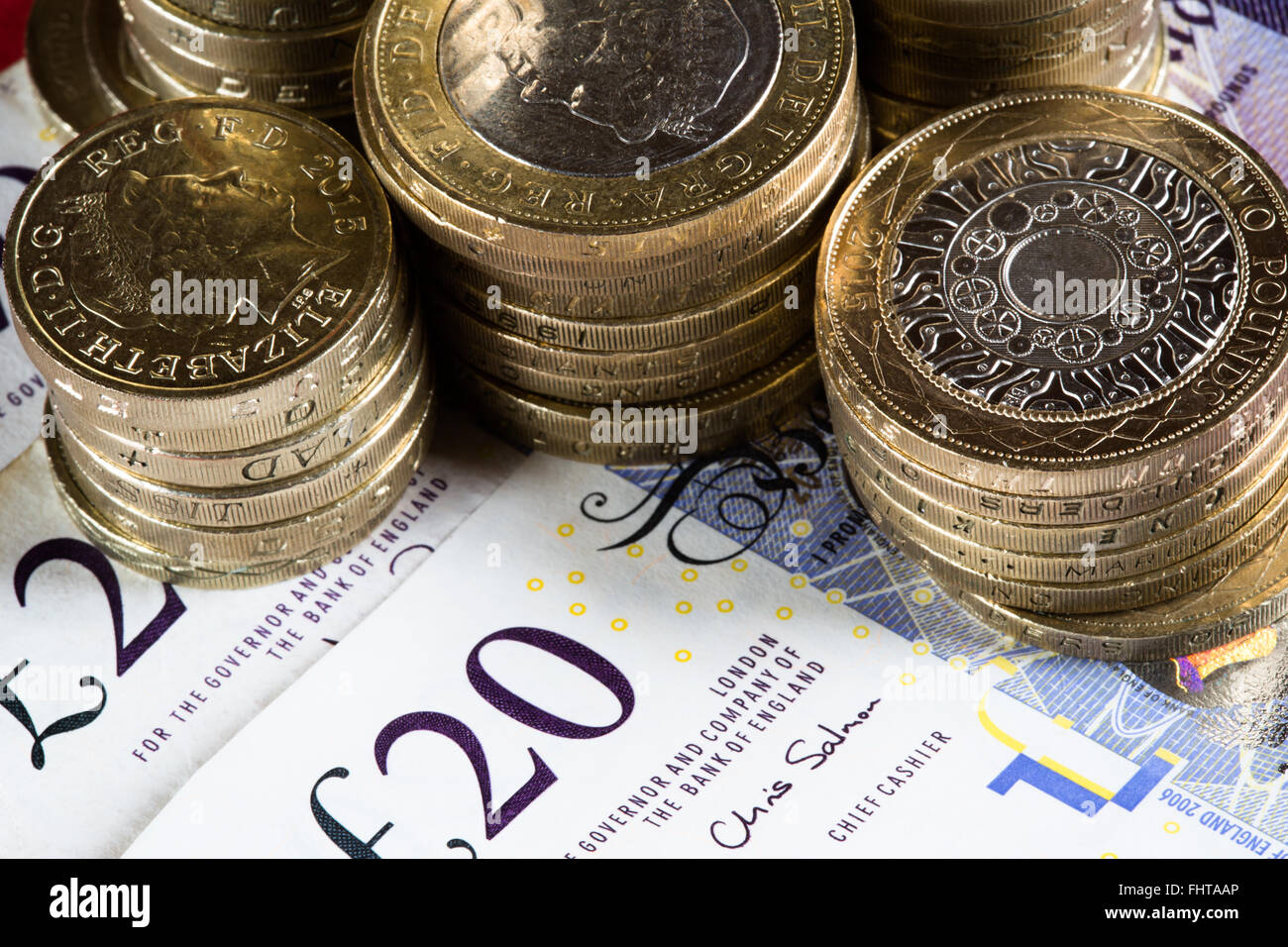 A macro image of coins and notes of the British Realm. Specifically Two Pound coins, One Pound 
