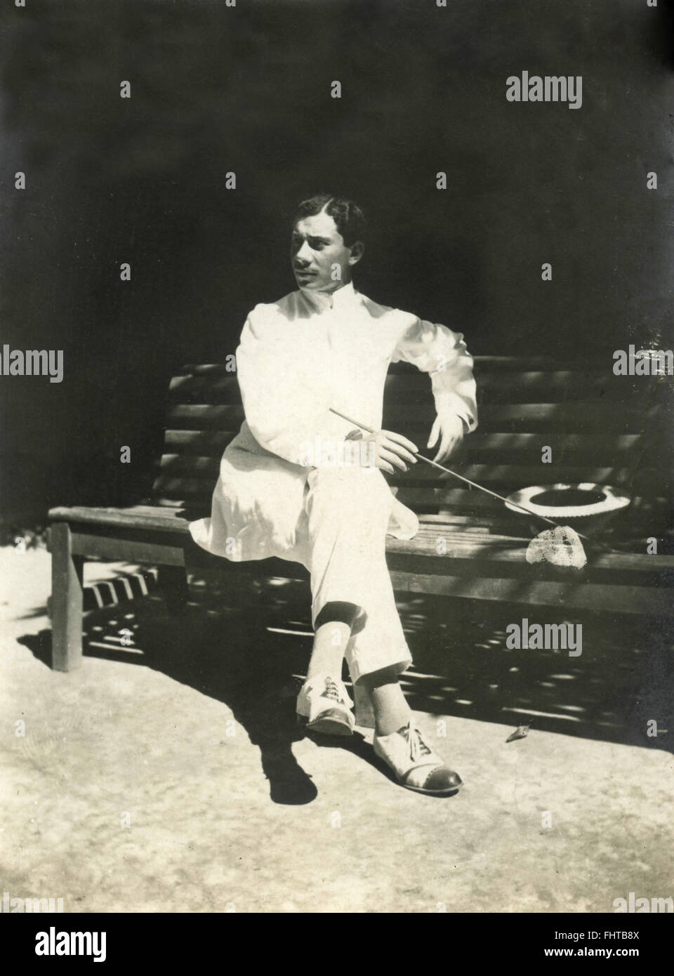 A man dressed in white on a bench, Italy Stock Photo - Alamy