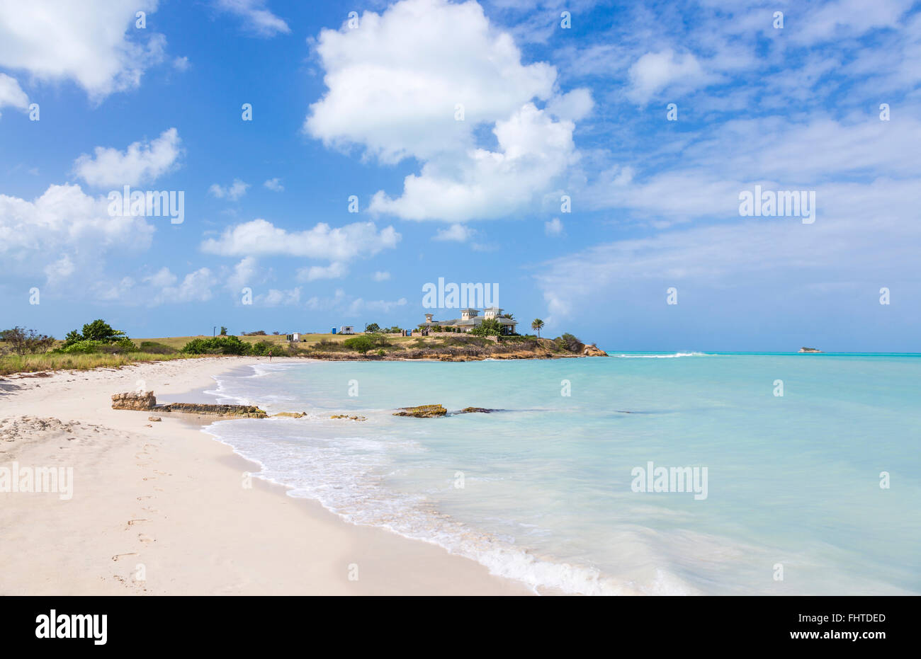 Beautiful deserted white sand beach and unspoilt shoreline in Dickenson Bay, north Antigua, Antigua and Barbuda, on a sunny day Stock Photo