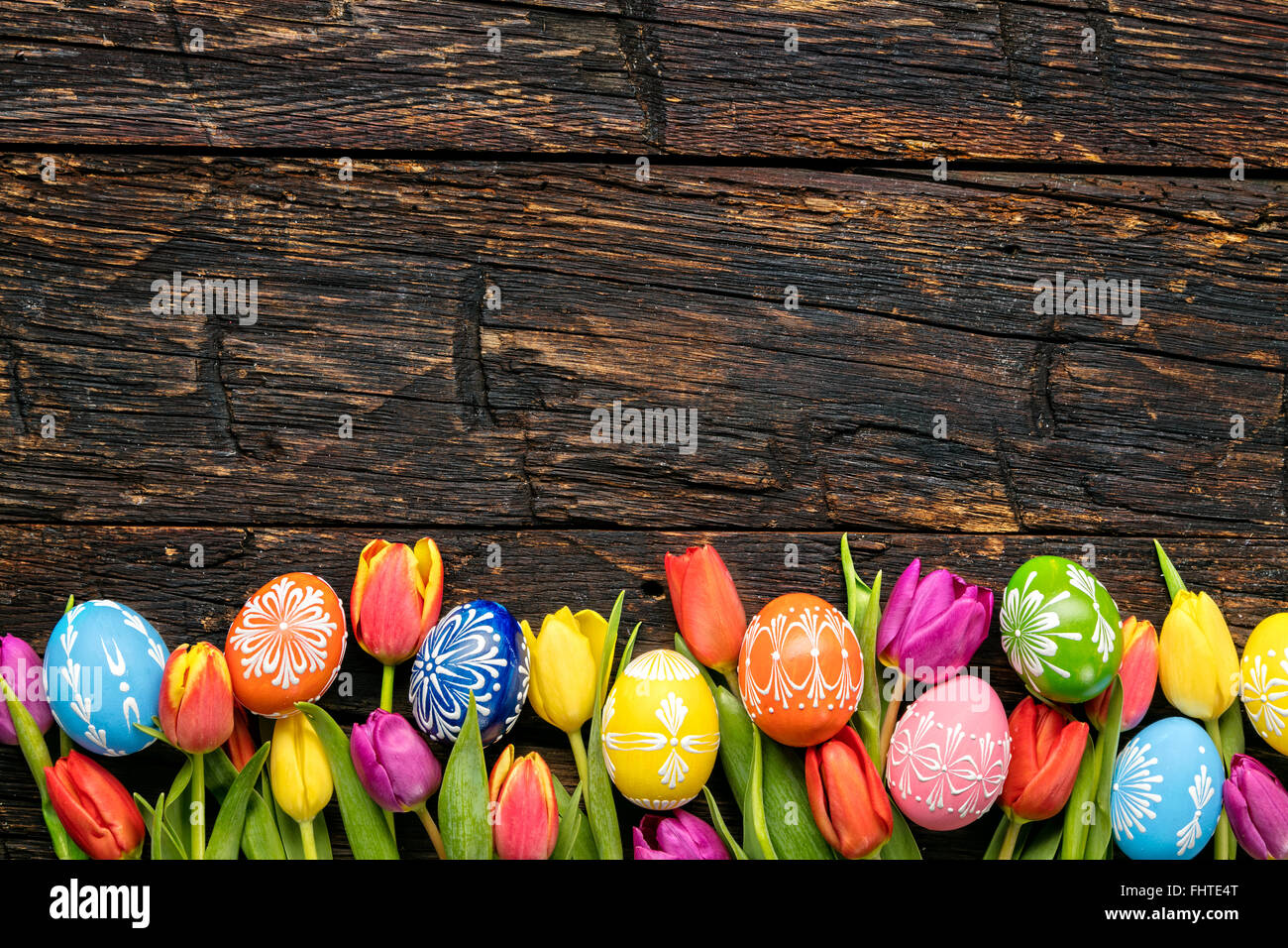 Easter eggs and tulips on wooden planks Stock Photo - Alamy