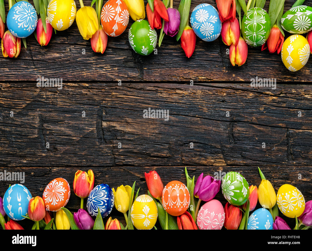 Easter eggs and tulips on wooden planks Stock Photo - Alamy
