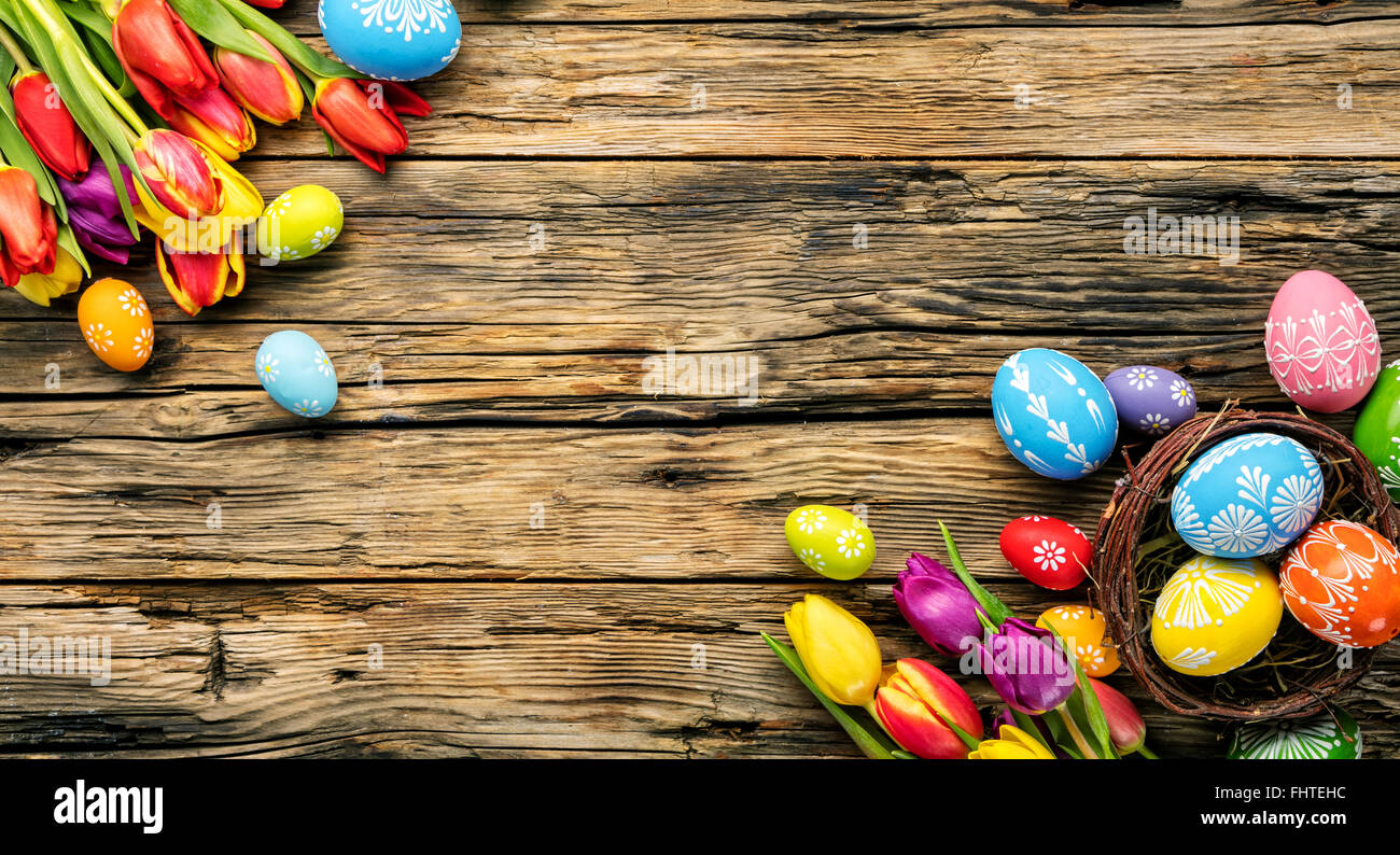 Easter eggs and tulips on wooden planks Stock Photo - Alamy