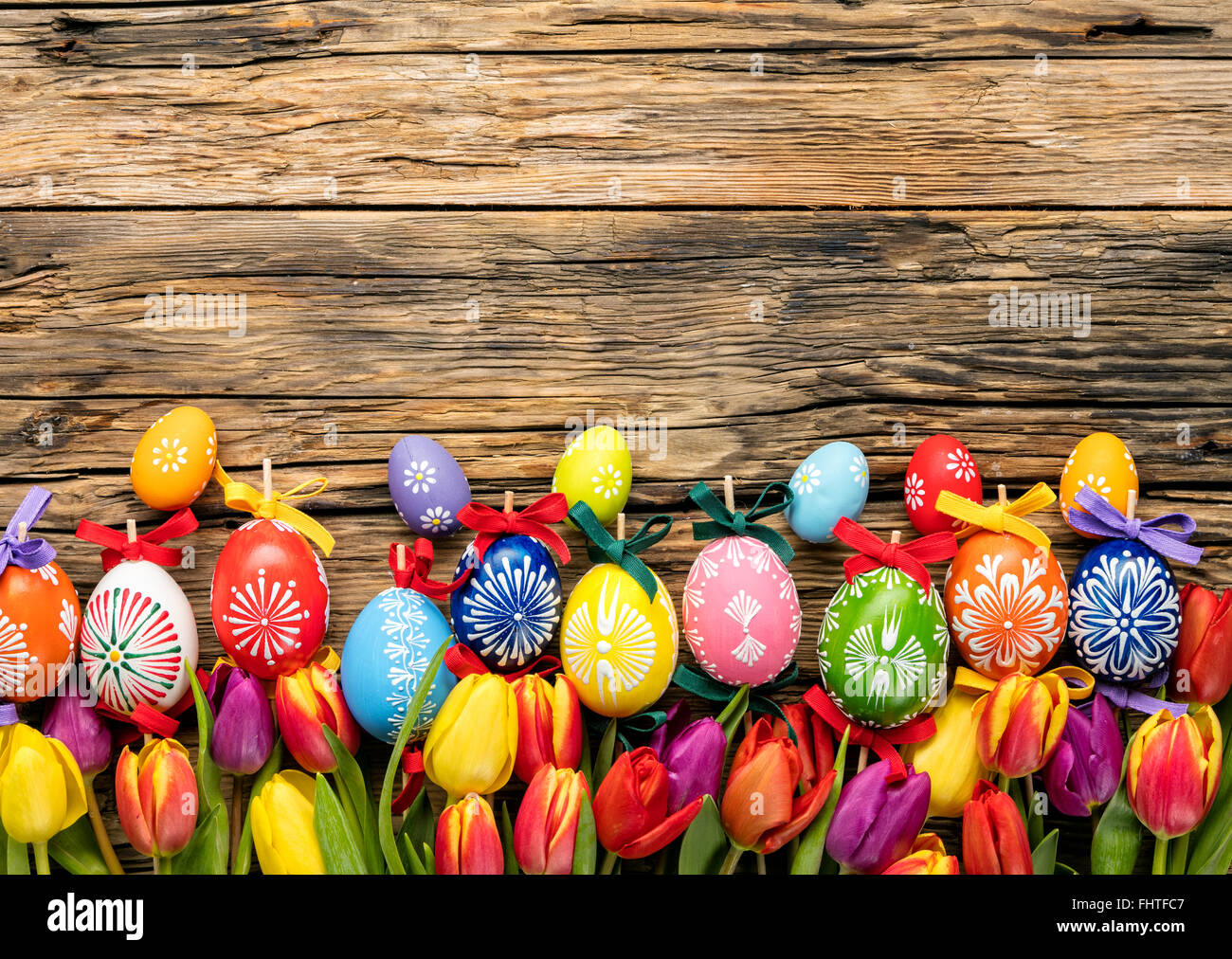 Easter eggs and tulips on wooden planks Stock Photo - Alamy