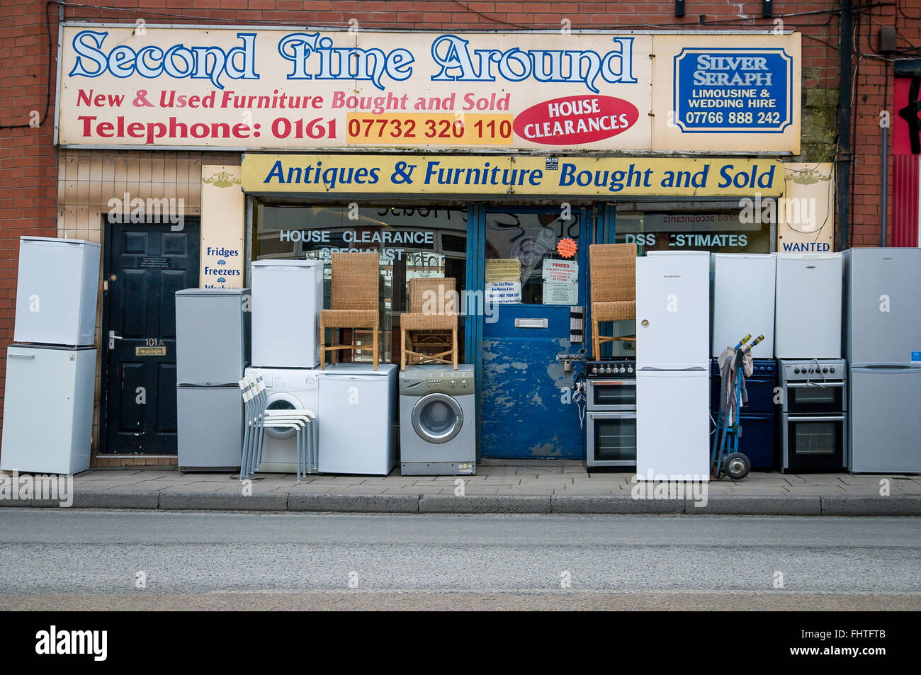 Past second hand shop with used goods displayed outside the entrance in Radcliffe, Manchester UK Stock Photo