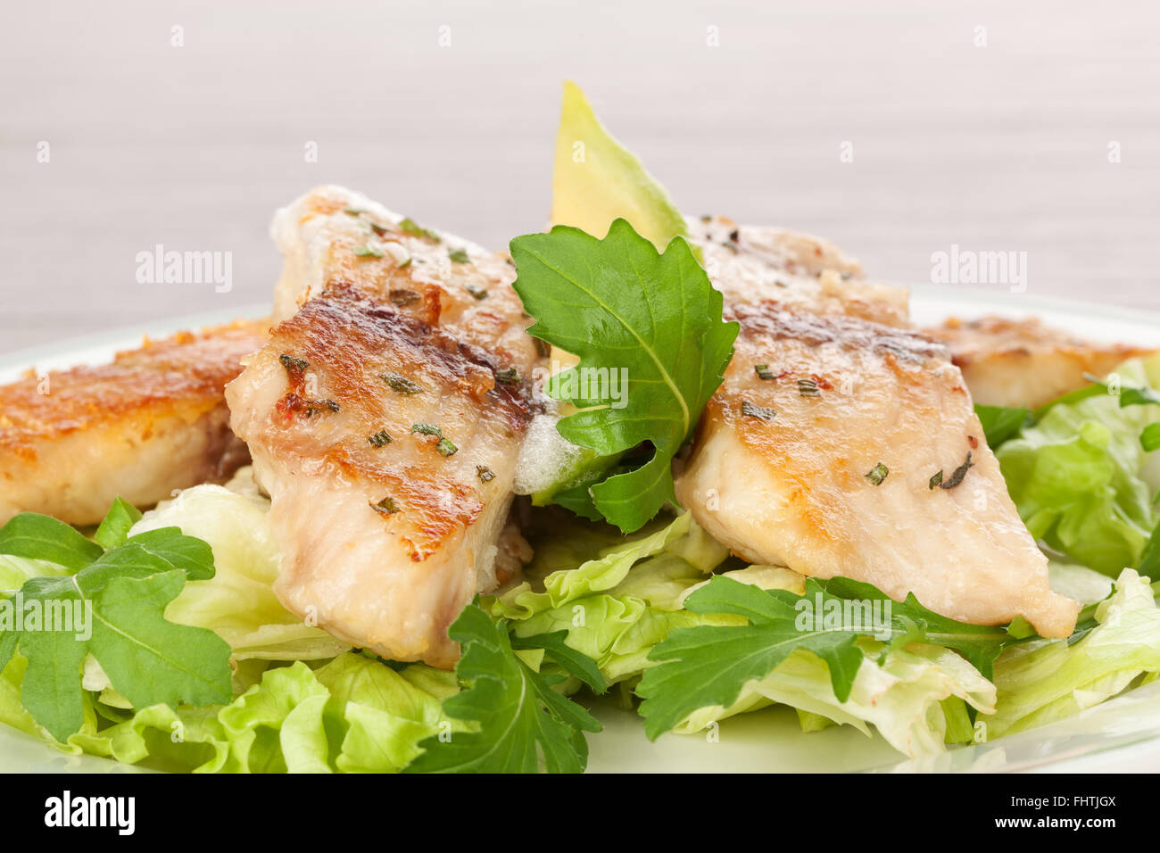 Fish fillet with fresh salad Stock Photo - Alamy