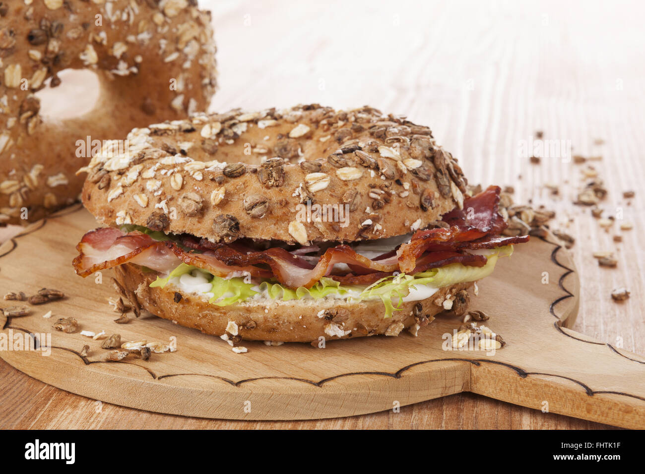 Whole grain bagel with bacon. Stock Photo