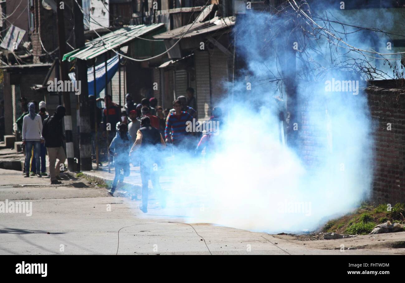 Kashmiri Muslim protesters run for cover as tear gas shell explode near ...