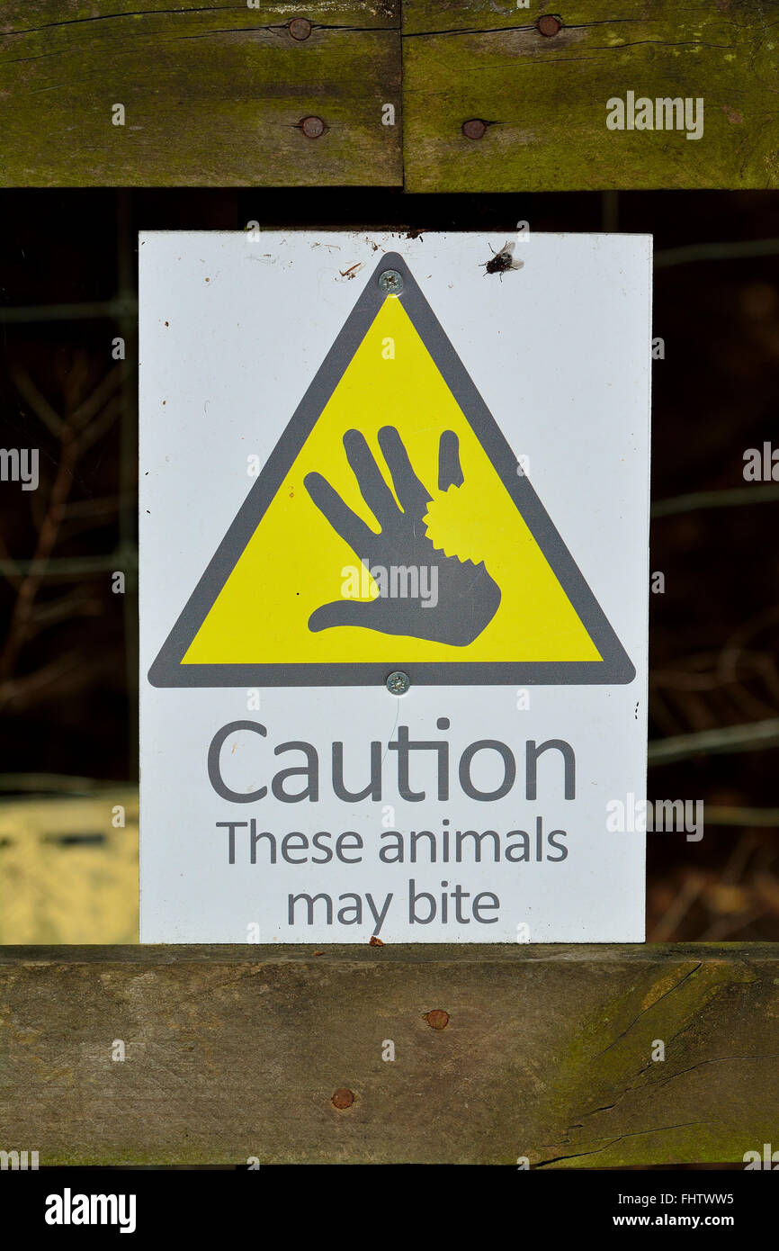 Warning Sign ' Caution These animals may bite' Stock Photo