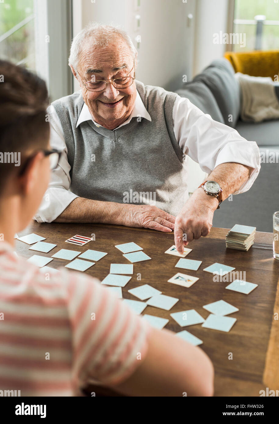 Senior man playing memory with his grandson Stock Photo