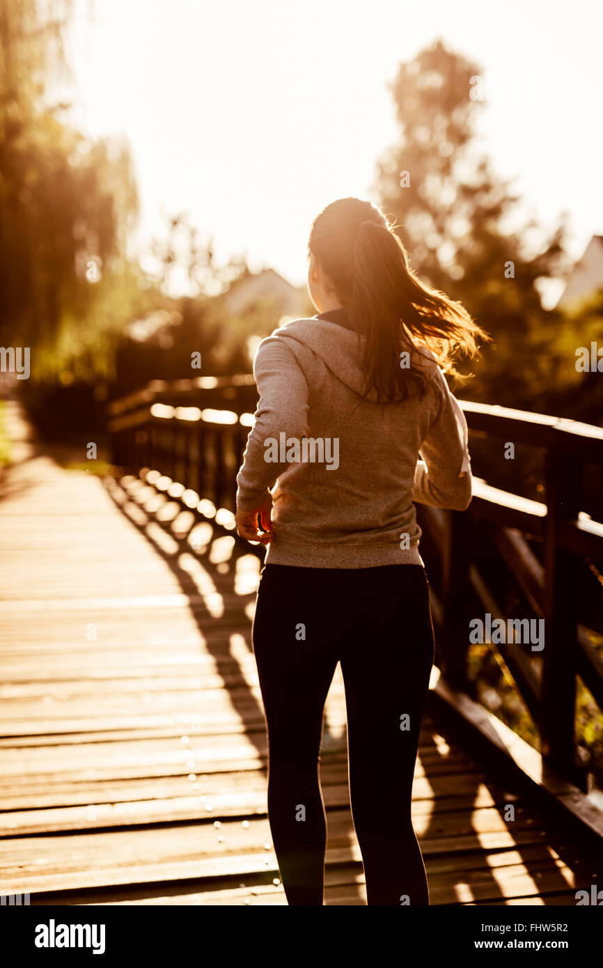 Female jogger exercising outdoors in nature Stock Photo