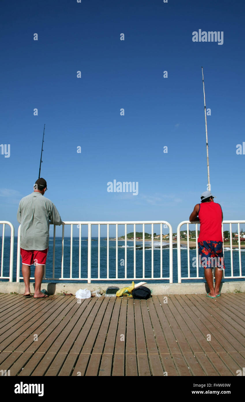 Men fishing on the pier Costazul the Oyster River Beach - RJ Stock Photo