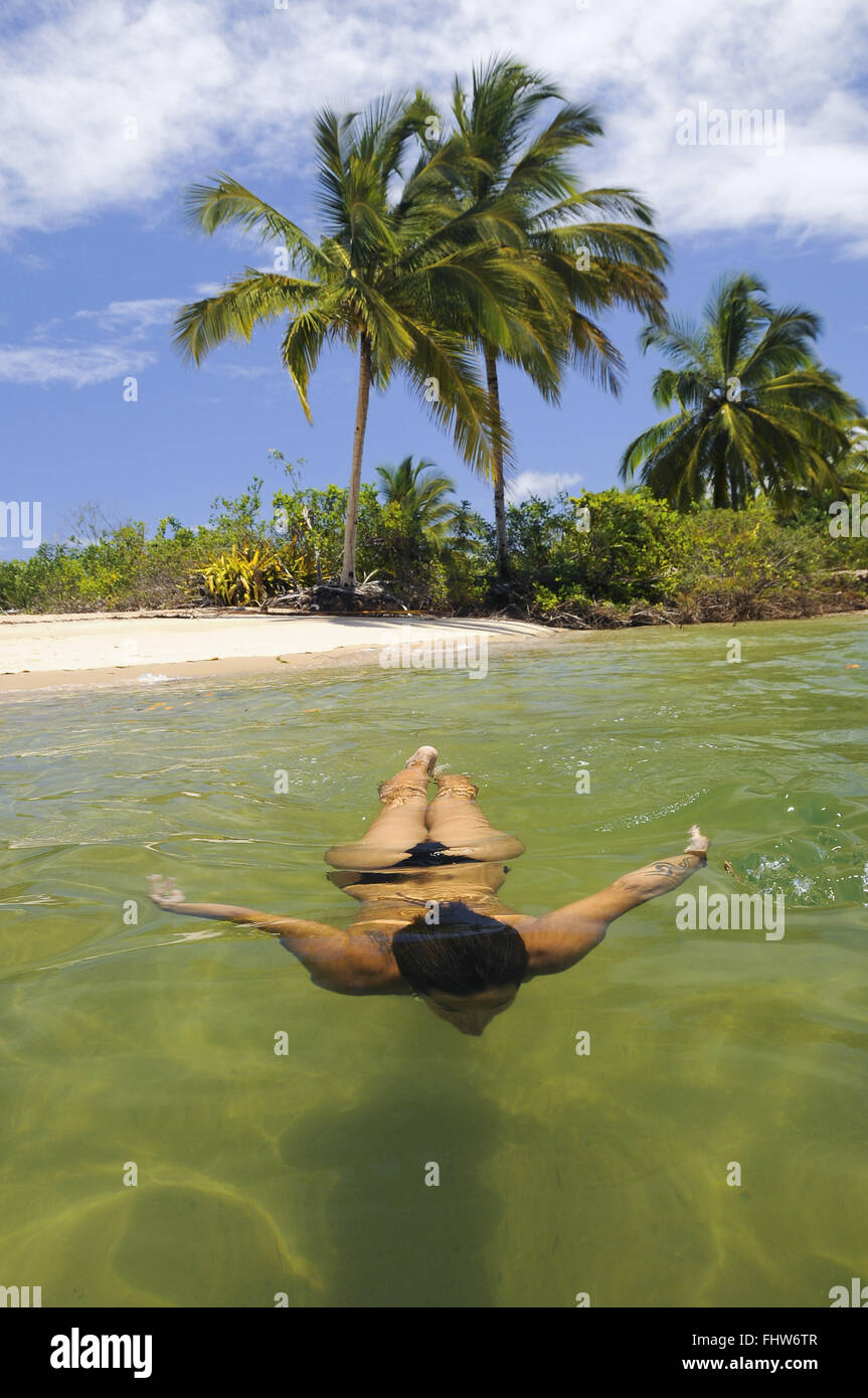 Tourist swims in the sea on the Island Thrush Stock Photo