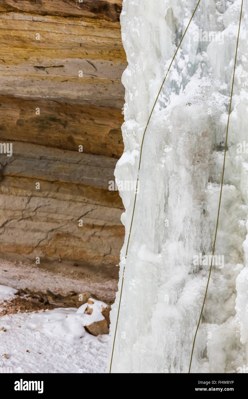 Ice climbing ropes on a frozen waterfall in Pictured Rocks National Lakeshore, Upper Peninsula, Michigan, USA Stock Photo