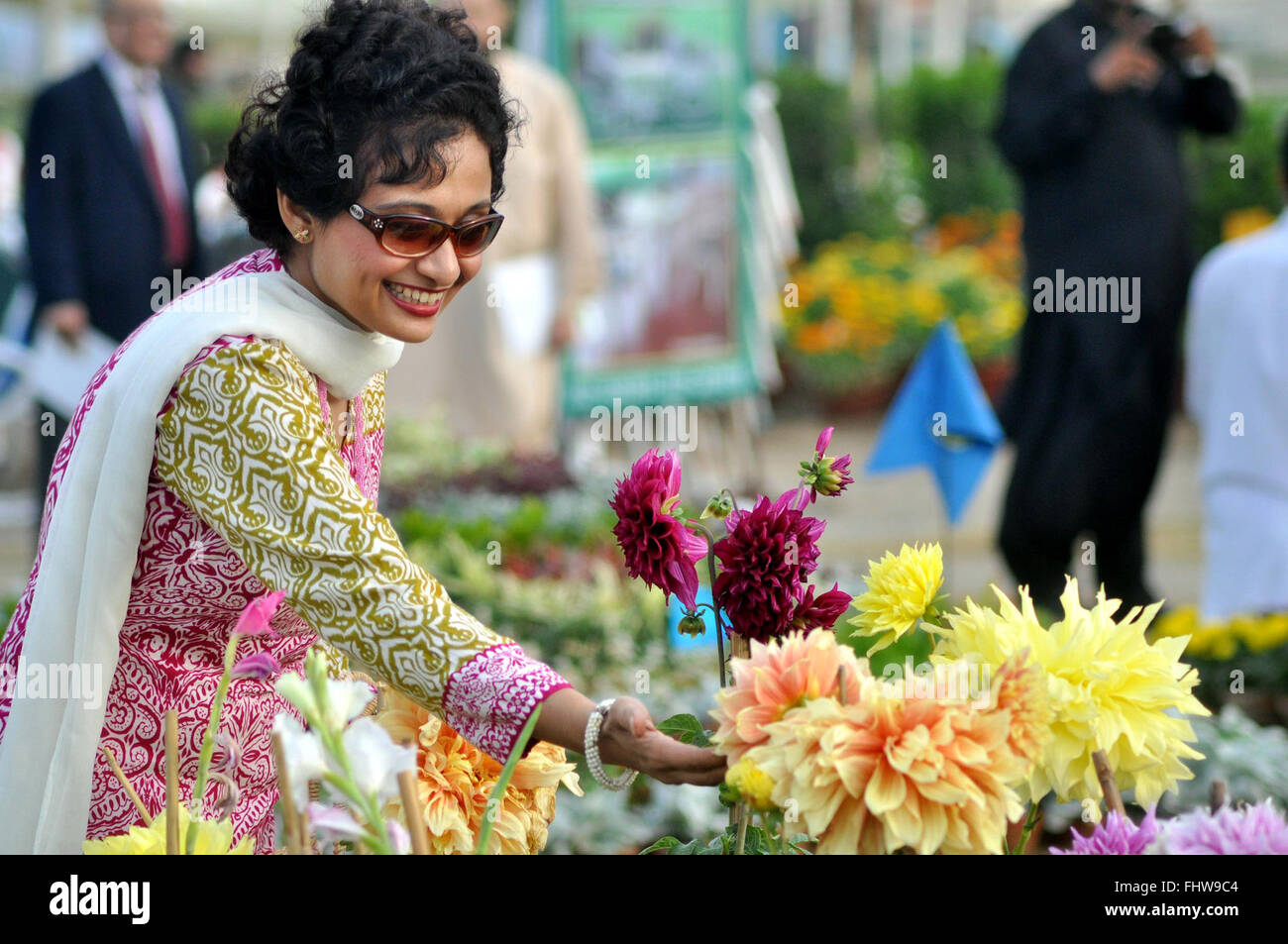 Karachi, Pakistan. 26th Feb, 2016. A woman smiles as she touches