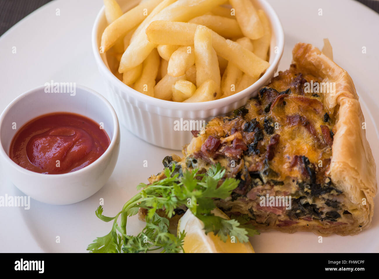 Homemade quiche with chips and tomato sauce Stock Photo