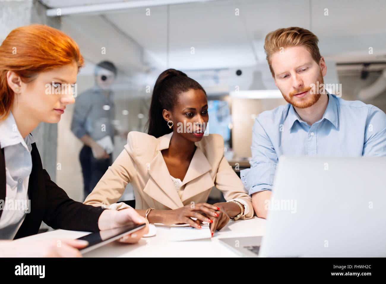 Group of business people sitting at desk and having a meeting about future strategy Stock Photo