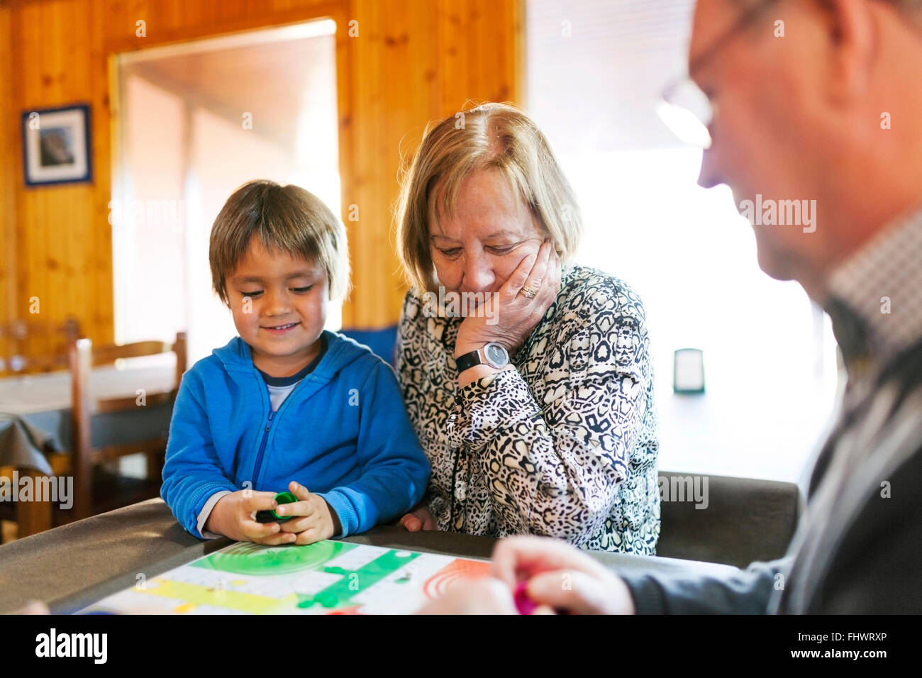 Grandparents playing ludo their grandson Stock Photo
