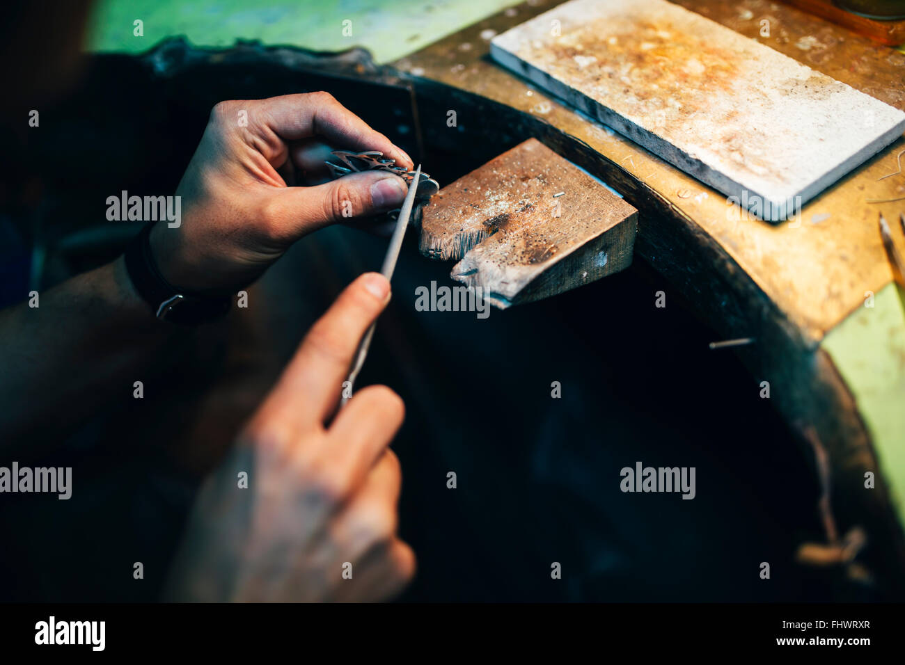 Jeweler polishing jewelry with tools Stock Photo Alamy