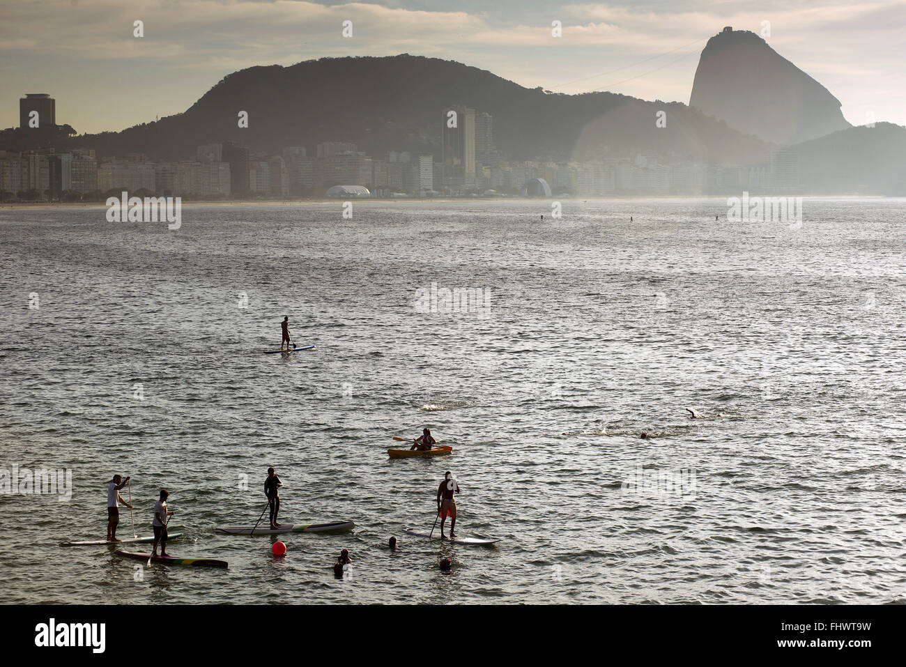 Swimming training and practice of stand up paddle SUP on Copacabana Beach Stock Photo