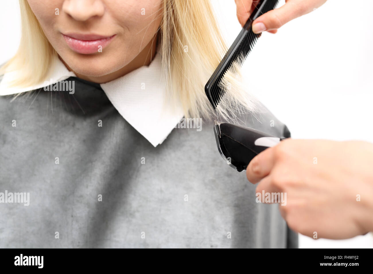 Cutting hair clippers. Haircut.. Woman hairdresser cuts hair tips Stock Photo