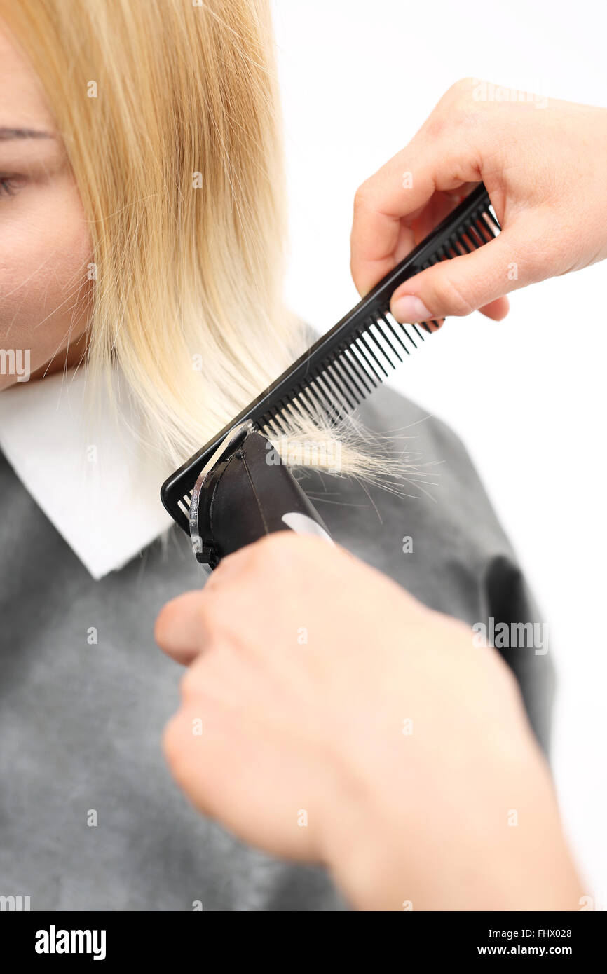 cutting woman's hair with clippers